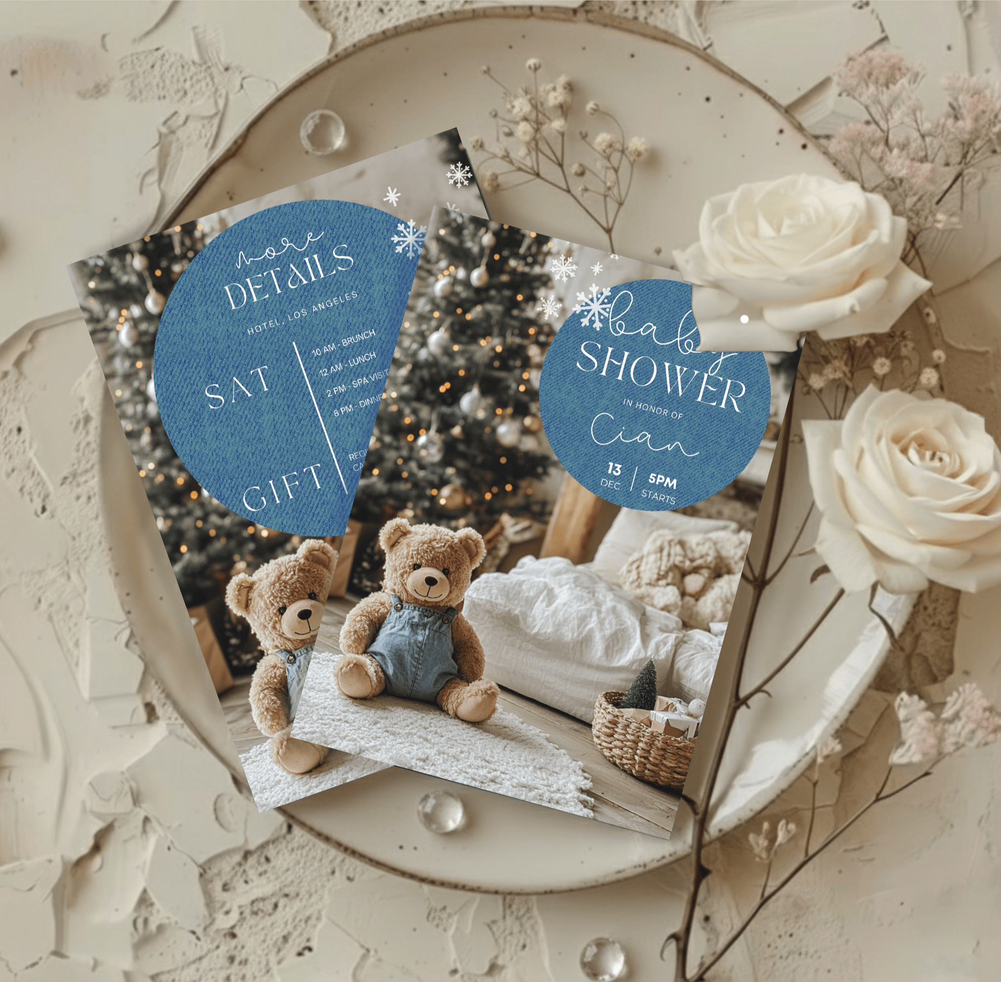 Matching denim baby shower invitation and details card with soft roses and neutral plate flatlay.